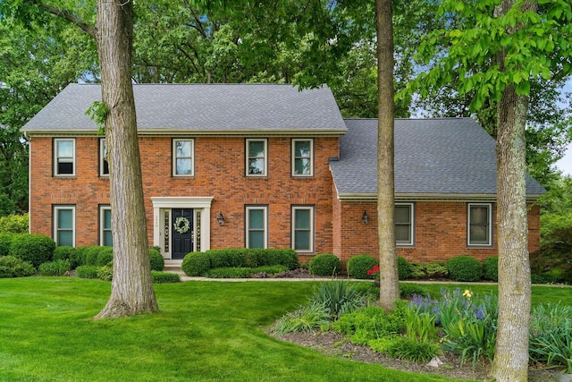 9440 Culross Ct, Dublin, OH 43017 - colonial home featuring a shingled roof, brick siding, and a front yard
