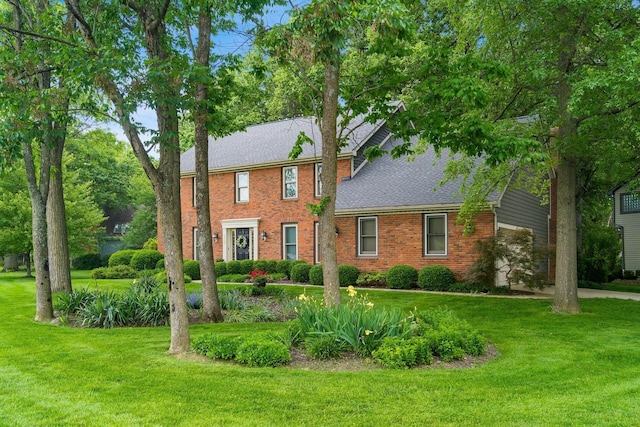 9440 Culross Ct, Dublin, OH 43017 - colonial inspired home featuring brick siding, a shingled roof, and a front yard