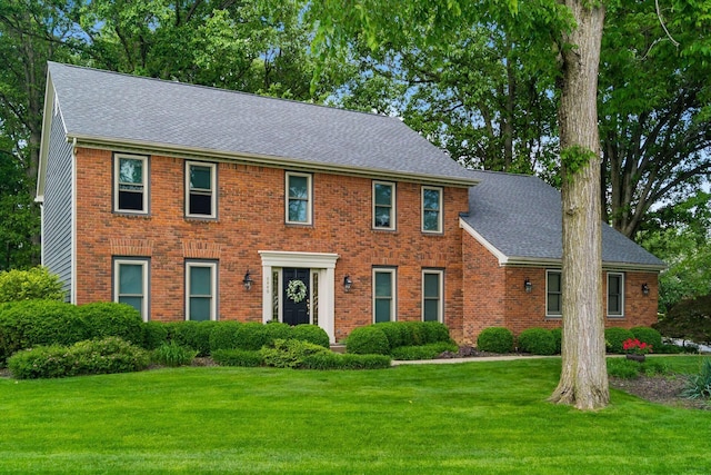 9440 Culross Ct, Dublin, OH 43017 - colonial house featuring a front lawn, a shingled roof, and brick siding