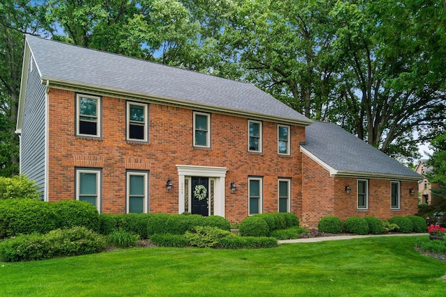 9440 Culross Ct, Dublin, OH 43017 - colonial house with a front yard, brick siding, and roof with shingles