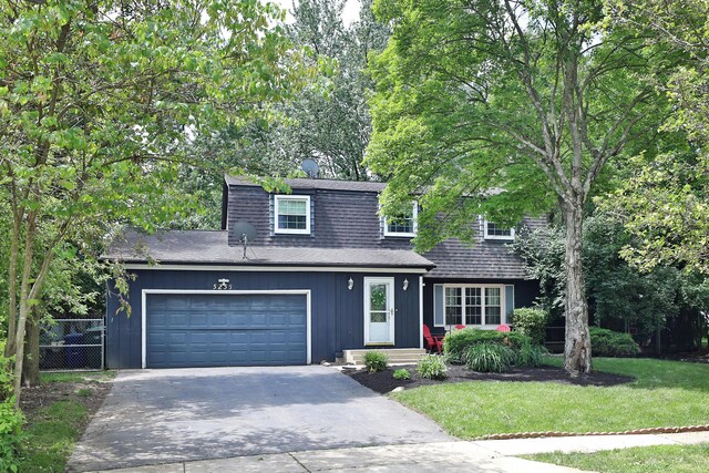5255 Dory Ln, Columbus, OH 43235 - dutch colonial featuring driveway, roof with shingles, and a garage