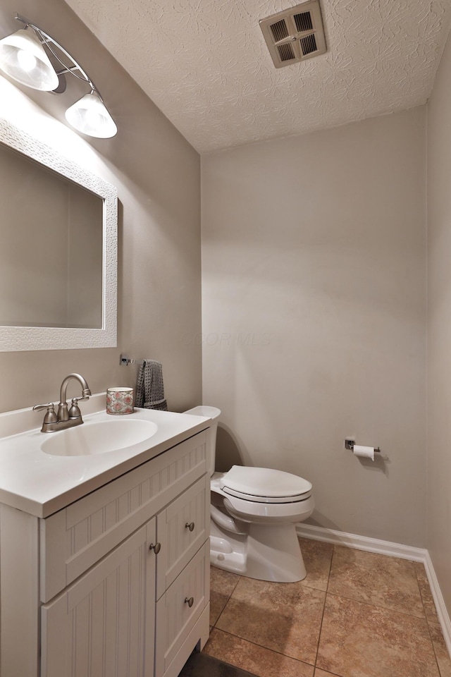 5255 Dory Ln, Columbus, OH 43235 - bathroom featuring toilet, vanity, tile patterned flooring, a textured ceiling, and baseboards
