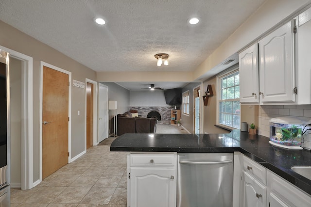 5255 Dory Ln, Columbus, OH 43235 - kitchen with a peninsula, stainless steel dishwasher, ceiling fan, a textured ceiling, and open floor plan