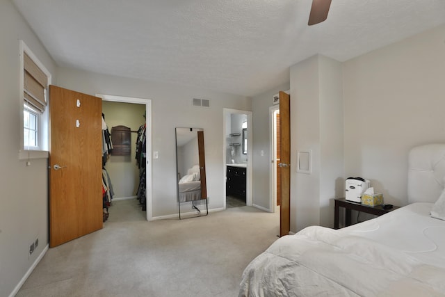 5255 Dory Ln, Columbus, OH 43235 - bedroom featuring light carpet, baseboards, a walk in closet, a closet, and ceiling fan