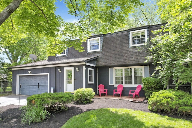 5255 Dory Ln, Columbus, OH 43235 - view of front of house featuring a shingled roof, an attached garage, concrete driveway, and board and batten siding