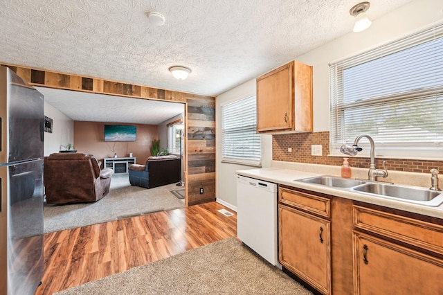 6588 Ethan Dr, Reynoldsburg, OH 43068 - kitchen with freestanding refrigerator, dishwasher, a sink, light wood finished floors, and open floor plan