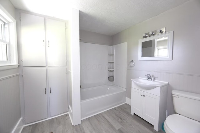 12 Montgomery Rd, Fredericktown, OH 43019 - full bathroom featuring wood finished floors, vanity, a textured ceiling, toilet, and wainscoting