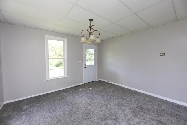 12 Montgomery Rd, Fredericktown, OH 43019 - spare room with a drop ceiling, dark carpet, a chandelier, and baseboards