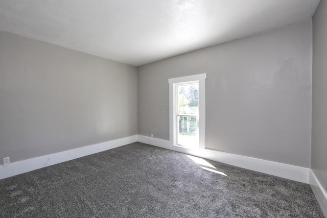 12 Montgomery Rd, Fredericktown, OH 43019 - empty room featuring dark colored carpet and baseboards
