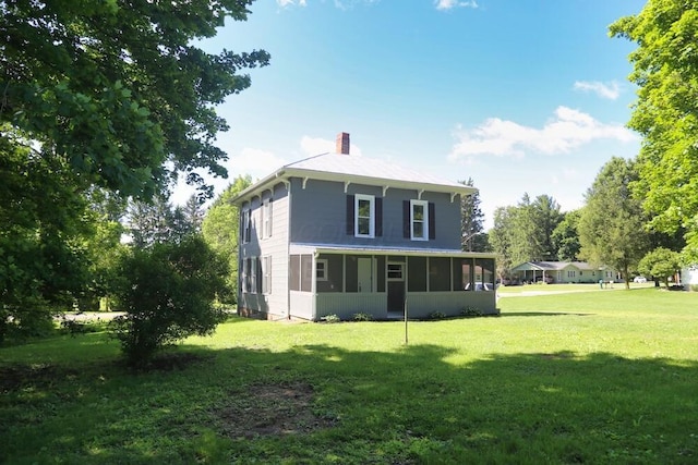 12 Montgomery Rd, Fredericktown, OH 43019 - back of house featuring a chimney, a sunroom, and a yard