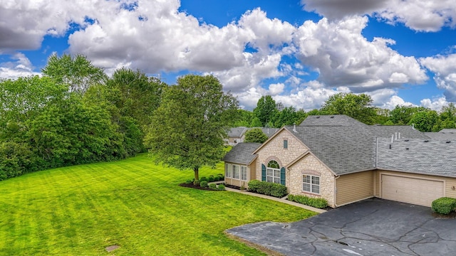 6973 Falls View Cir, Delaware, OH 43015 - french country home featuring stone siding, driveway, a front yard, a garage, and a shingled roof