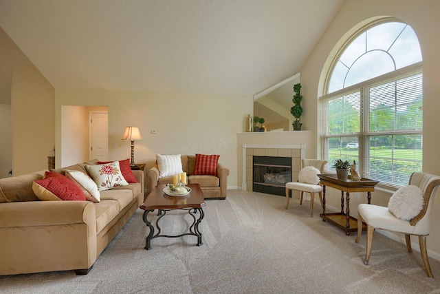 6973 Falls View Cir, Delaware, OH 43015 - carpeted living room featuring plenty of natural light, lofted ceiling, a tile fireplace, and baseboards
