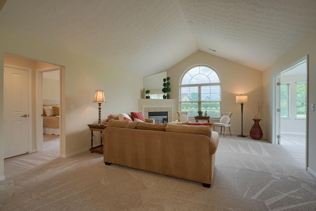 6973 Falls View Cir, Delaware, OH 43015 - carpeted living room with a tile fireplace, vaulted ceiling, baseboards, and a textured ceiling
