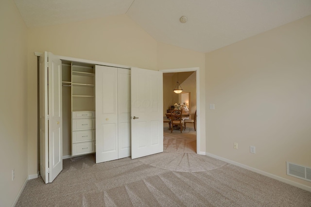 6973 Falls View Cir, Delaware, OH 43015 - unfurnished bedroom with vaulted ceiling, carpet floors, a closet, and baseboards