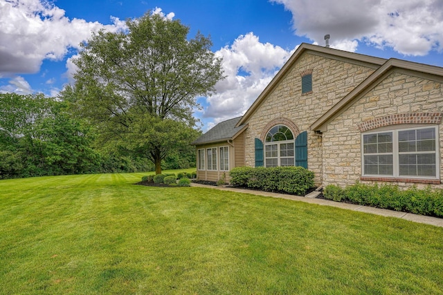 6973 Falls View Cir, Delaware, OH 43015 - view of property exterior with stone siding and a lawn