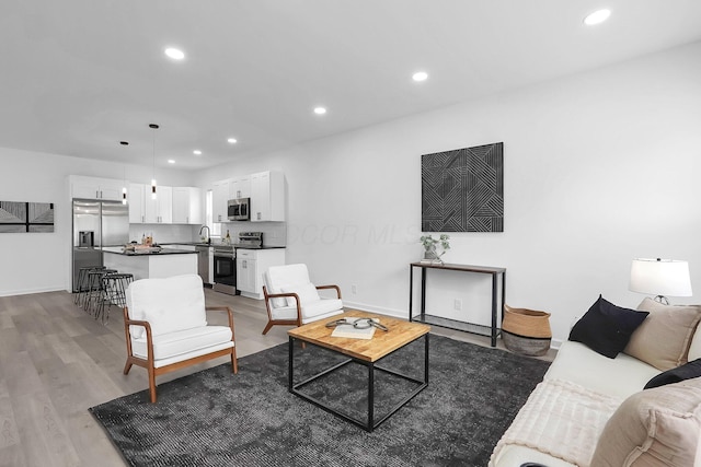 1191 Seymour Ave, Columbus, OH 43206 - living area with light wood finished floors, recessed lighting, and baseboards