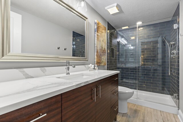 4477 Ackerly Farm Rd, New Albany, OH 43054 - full bath featuring vanity, toilet, a stall shower, wood finished floors, and a textured ceiling