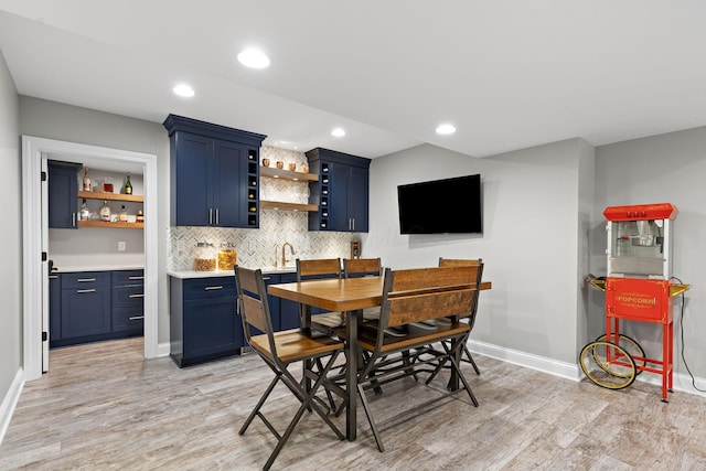 4477 Ackerly Farm Rd, New Albany, OH 43054 - dining room with bar with sink, light wood-type flooring, baseboards, and recessed lighting