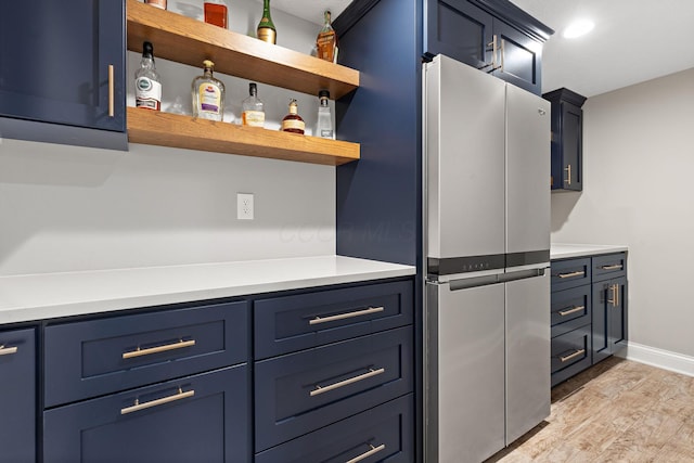 4477 Ackerly Farm Rd, New Albany, OH 43054 - kitchen featuring freestanding refrigerator, blue cabinets, light wood-style flooring, and light countertops
