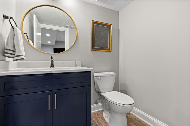 4477 Ackerly Farm Rd, New Albany, OH 43054 - bathroom with baseboards, vanity, wood finished floors, toilet, and a textured ceiling