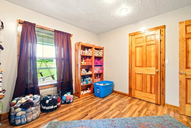 19160 Coshocton Rd, Mount Vernon, OH 43050 - playroom with wood finished floors, a textured ceiling, and baseboards