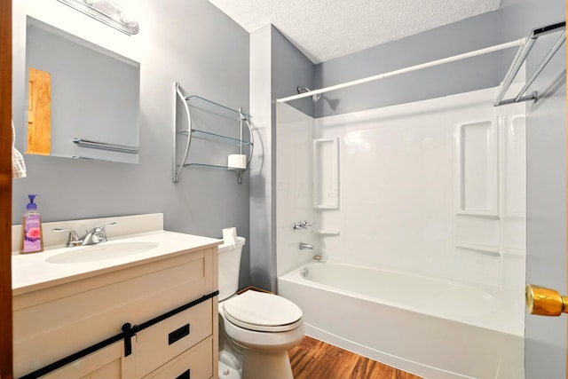19160 Coshocton Rd, Mount Vernon, OH 43050 - bathroom featuring wood finished floors, toilet, tub / shower combination, vanity, and a textured ceiling