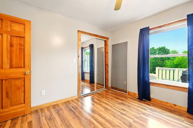 19160 Coshocton Rd, Mount Vernon, OH 43050 - unfurnished bedroom featuring light wood finished floors, baseboards, ceiling fan, and a closet