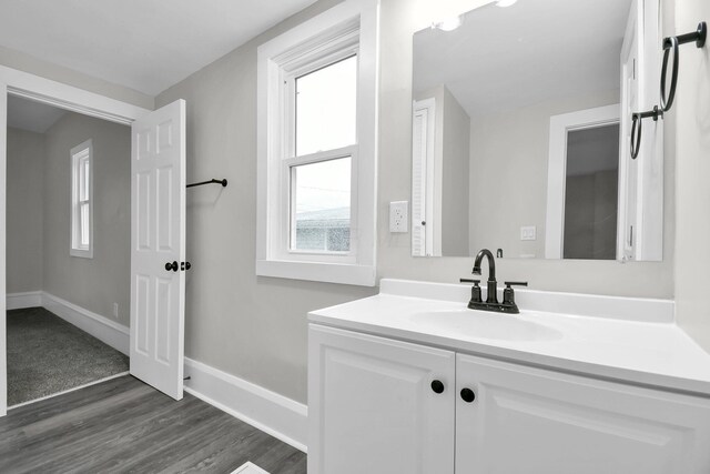 44 W 4th St, Fredericktown, OH 43019 - bathroom with vanity, wood finished floors, and baseboards