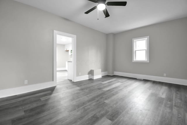44 W 4th St, Fredericktown, OH 43019 - spare room with a ceiling fan, dark wood-type flooring, and baseboards