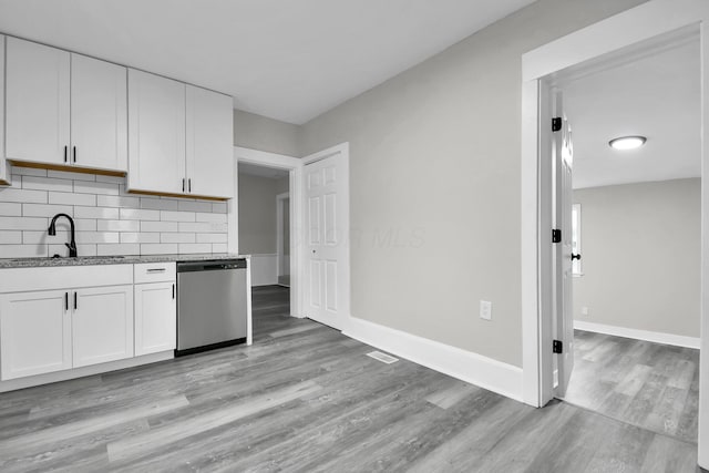 44 W 4th St, Fredericktown, OH 43019 - kitchen with dishwasher, a sink, white cabinetry, light wood-style floors, and decorative backsplash
