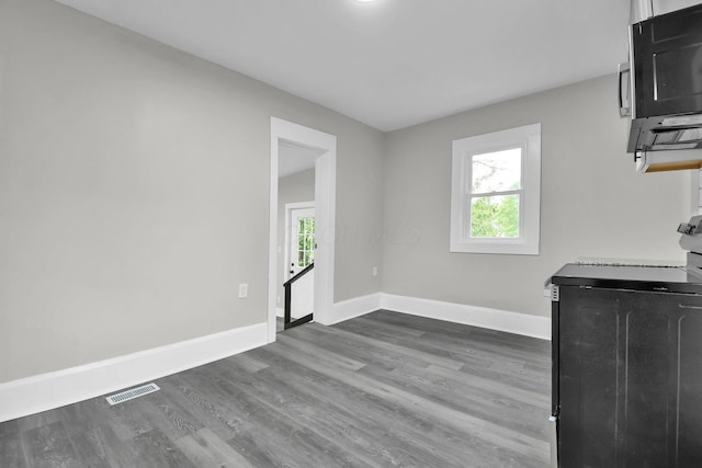 44 W 4th St, Fredericktown, OH 43019 - unfurnished dining area with baseboards and dark wood-type flooring