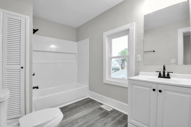 44 W 4th St, Fredericktown, OH 43019 - bathroom featuring wood finished floors, toilet, vanity, shower / bathtub combination, and a closet