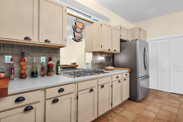 2149 Baptist Hill Rd, Chillicothe, OH 45601 - kitchen with stainless steel appliances, backsplash, light countertops, and cream cabinetry