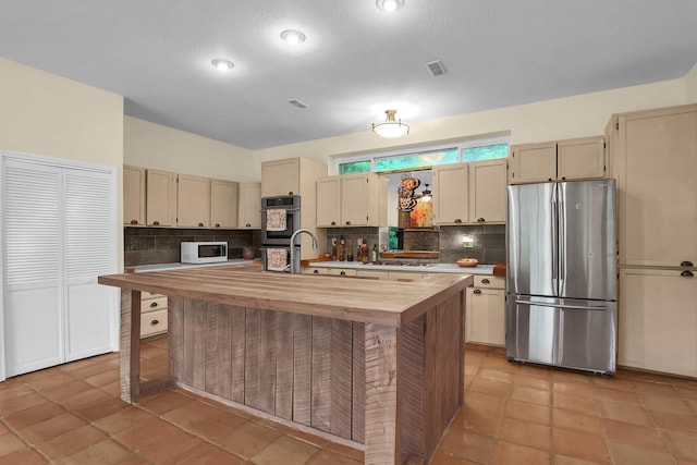 2149 Baptist Hill Rd, Chillicothe, OH 45601 - kitchen featuring white appliances, butcher block countertops, decorative backsplash, and a center island with sink