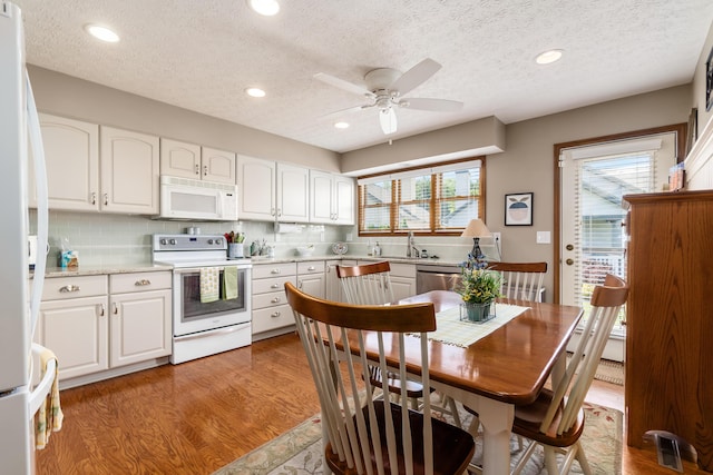 4995 Softwood Ct, Westerville, OH 43081 - kitchen featuring white appliances, a textured ceiling, a sink, white cabinetry, and decorative backsplash