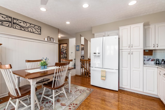 4995 Softwood Ct, Westerville, OH 43081 - dining area featuring light wood finished floors, a textured ceiling, and recessed lighting