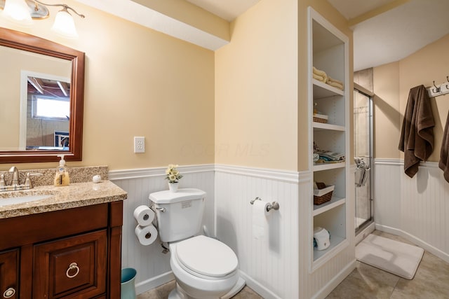 4995 Softwood Ct, Westerville, OH 43081 - bathroom featuring wainscoting, a shower stall, vanity, toilet, and tile patterned flooring