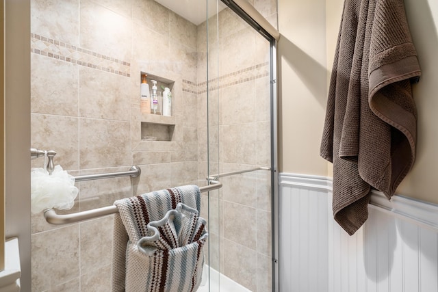 4995 Softwood Ct, Westerville, OH 43081 - full bathroom featuring a tile shower, wainscoting, and a decorative wall