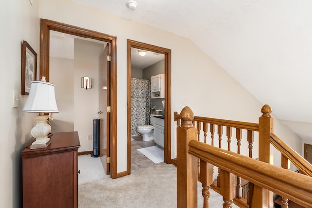 4995 Softwood Ct, Westerville, OH 43081 - corridor featuring an upstairs landing, light carpet, lofted ceiling, and baseboards