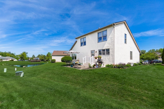 4995 Softwood Ct, Westerville, OH 43081 - rear view of property featuring a lawn, stucco siding, a patio, and a water view