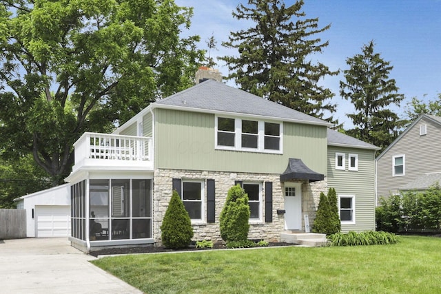 2615 NW Blvd, Upper Arlington, OH 43221 - view of front of house with stone siding, a balcony, a front yard, a chimney, and an outbuilding