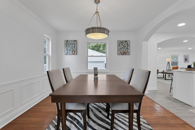 2615 NW Blvd, Upper Arlington, OH 43221 - dining area featuring arched walkways, light wood-type flooring, ornamental molding, wainscoting, and a decorative wall