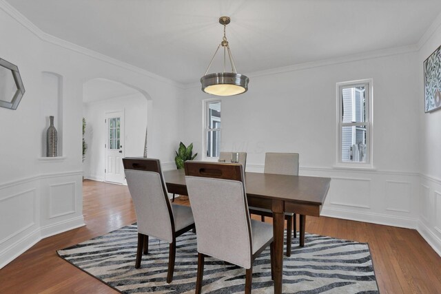 2615 NW Blvd, Upper Arlington, OH 43221 - dining room featuring arched walkways, wood finished floors, a wainscoted wall, and ornamental molding