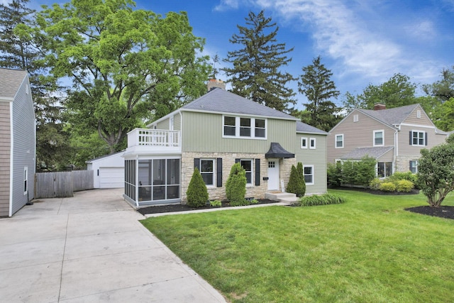2615 NW Blvd, Upper Arlington, OH 43221 - traditional-style home with stone siding, a balcony, a detached garage, a chimney, and a shingled roof