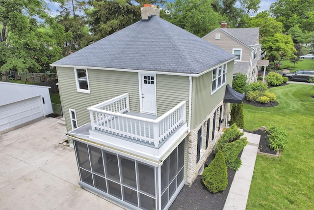 2615 NW Blvd, Upper Arlington, OH 43221 - back of house with a shingled roof, a balcony, a chimney, a sunroom, and an outbuilding