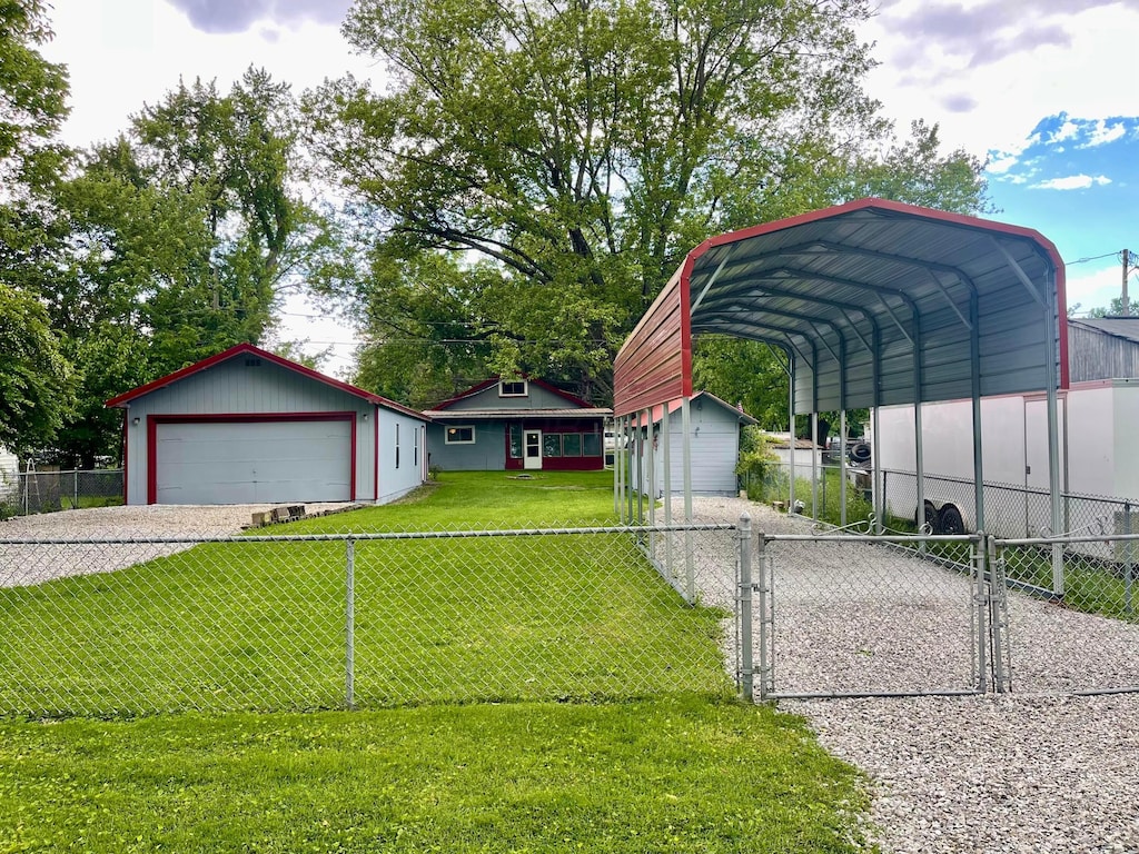 13424 Ivy Rd NE, Thornville, OH 43076 - view of front facade featuring an outbuilding, a detached garage, a gate, and a detached carport