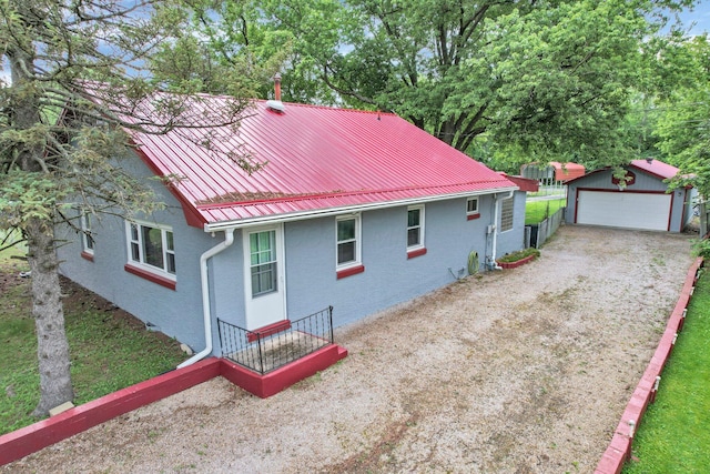 13424 Ivy Rd NE, Thornville, OH 43076 - rear view of house with an outdoor structure, a garage, a metal roof, and a standing seam roof