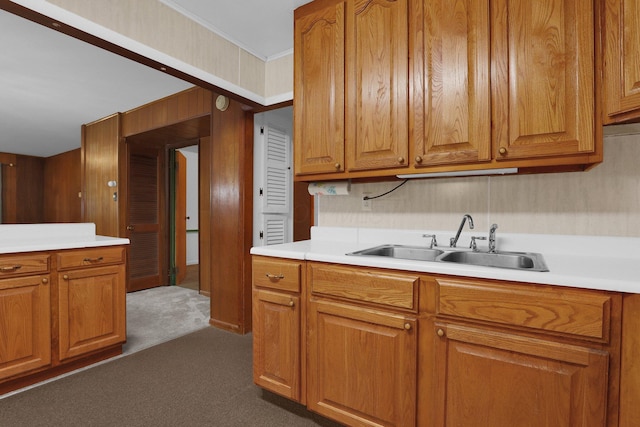 13424 Ivy Rd NE, Thornville, OH 43076 - kitchen featuring dark colored carpet, light countertops, brown cabinets, and crown molding