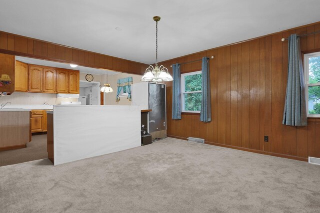 13424 Ivy Rd NE, Thornville, OH 43076 - kitchen with plenty of natural light, carpet flooring, brown cabinets, and wooden walls