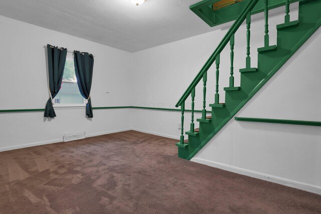 13424 Ivy Rd NE, Thornville, OH 43076 - carpeted empty room with stairway and a textured ceiling